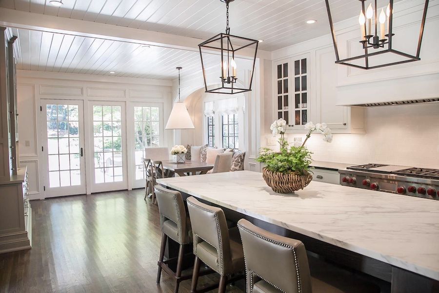 brookhaven tudor kitchen long shot of island looking out towards back patio