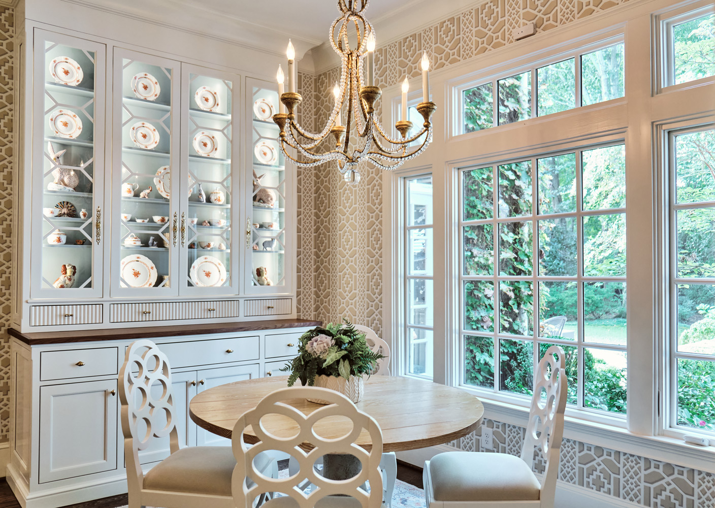 the breakfast area with beige and dark wood custom built in hutch displaying fine china