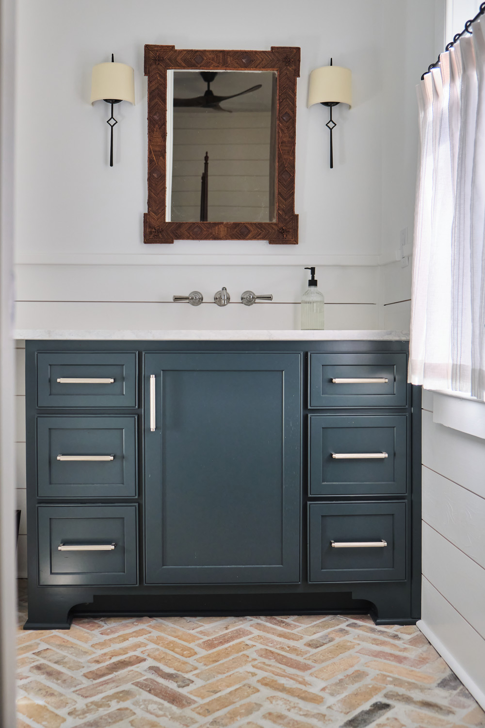 a dark blue vanity with silver hardware