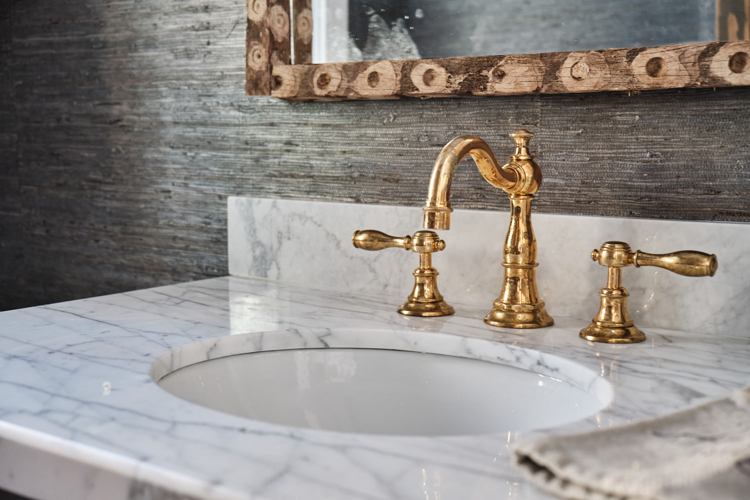 carrera marble sink top and brass hardware in the main floor bathroom