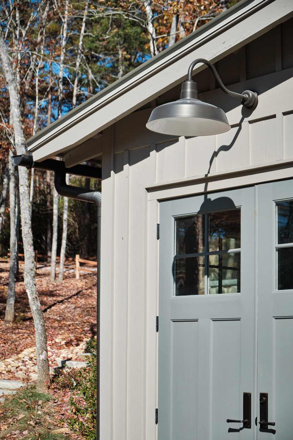 a barn light on the shed matches the lights on the boat house nearby