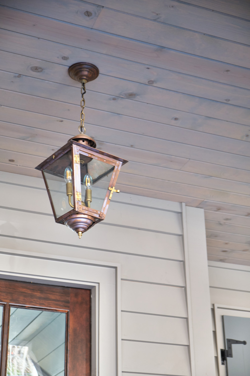 detailed view of the brass lantern hanging on the front porch