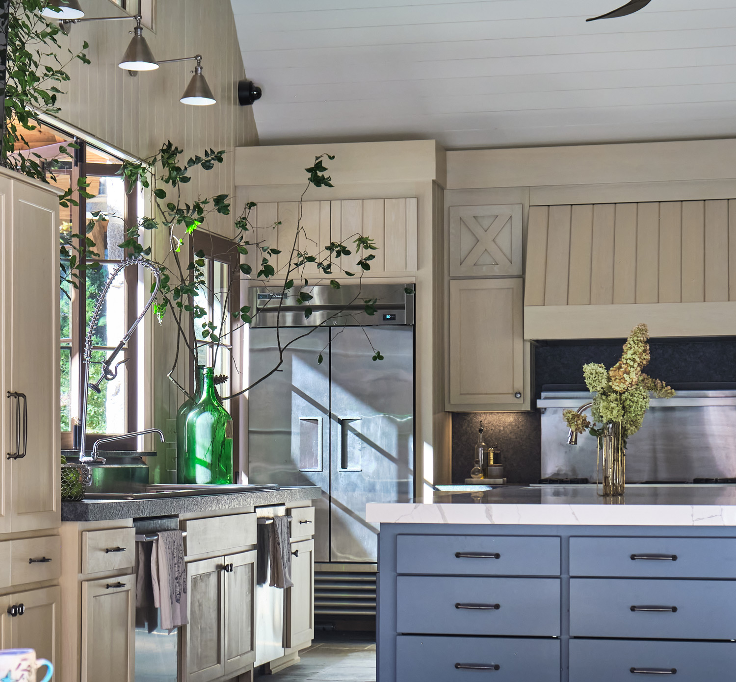 the sunlit industrial pool house kitchen with stone floors