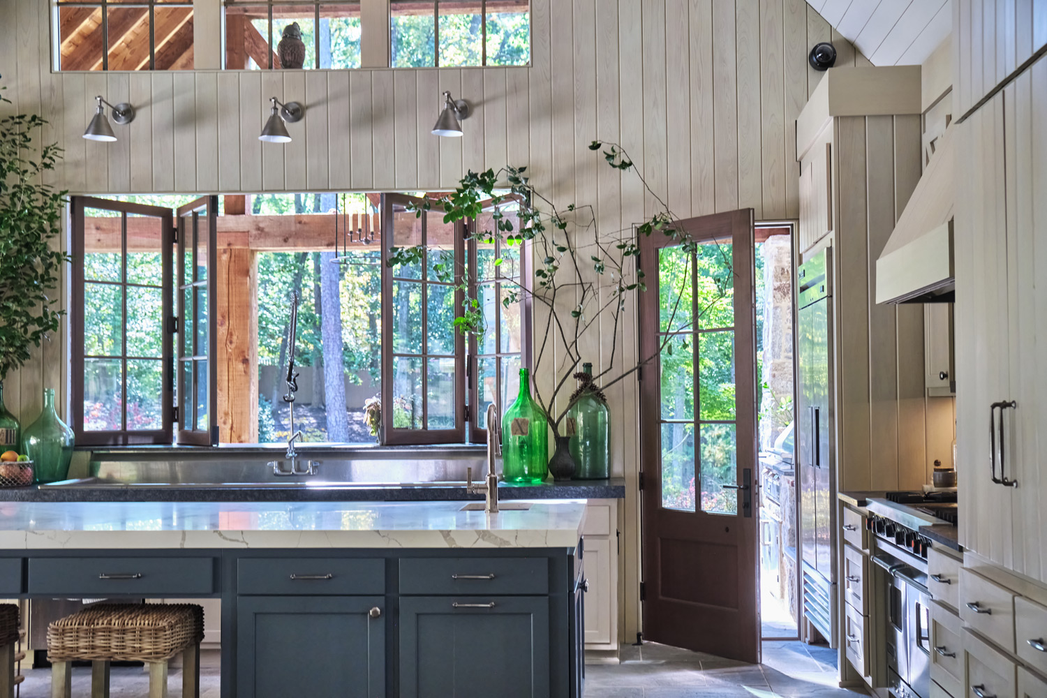 the blue island in the pool house kitchen with lots of natural light